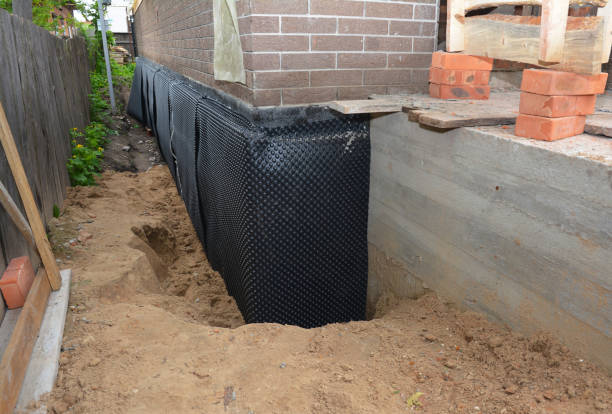 SJ Waterproofing Pros technician performing targeted Waterproofing assessment in Kings Park, NY